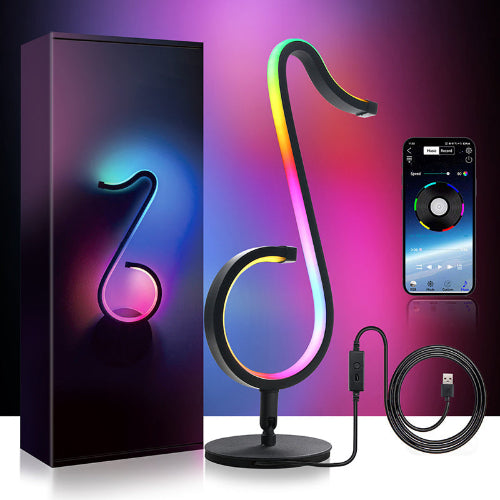 Colorful lamp shaped like a musical note with packaging, smartphone, and cable on a reflective surface. RGB Illuminations